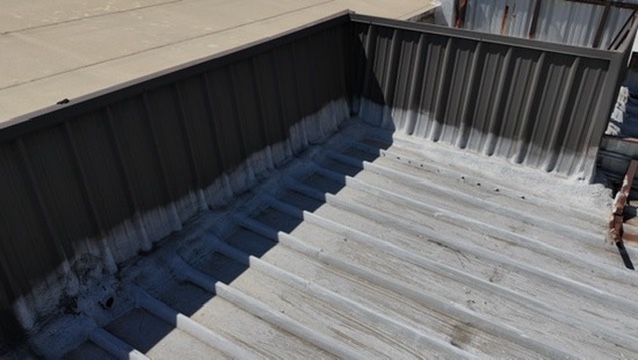 drainage check inspection on metal roof in Dallas, TX