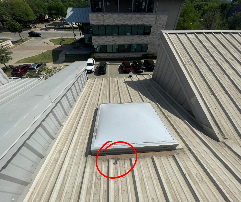 Failed metal roof coating peeling off around seam on commercial roof in Dallas