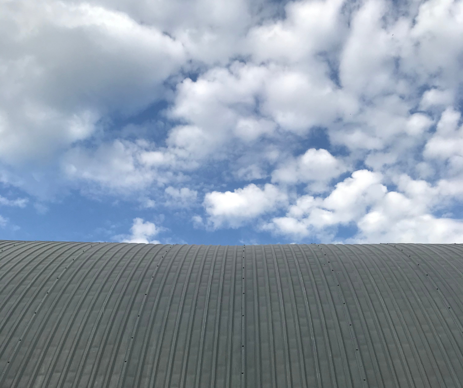 Hail damage metal roof restoration DFW showing dents on standing seam panel
